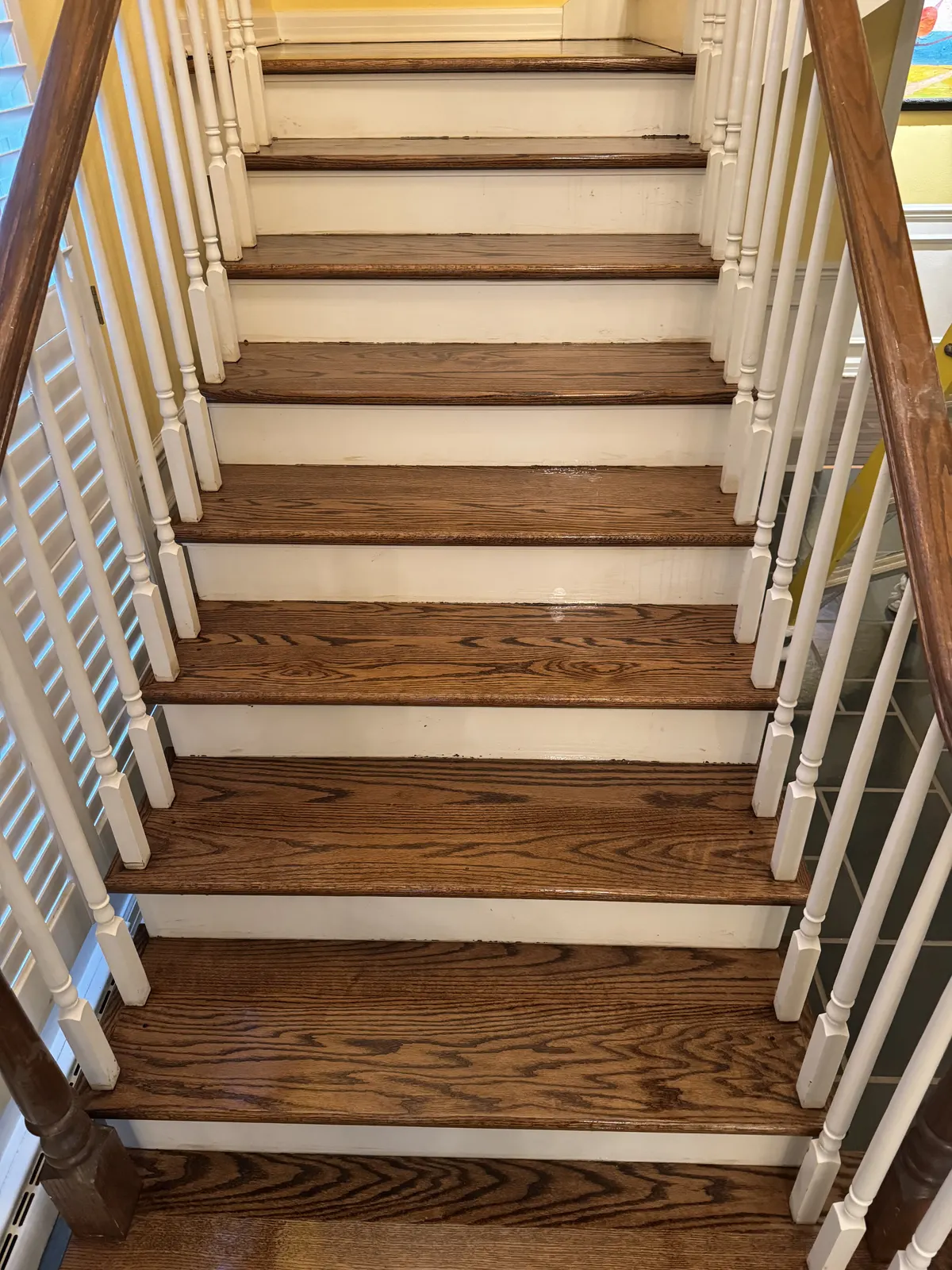 Refinished oak staircase with white risers in a Fox Point home