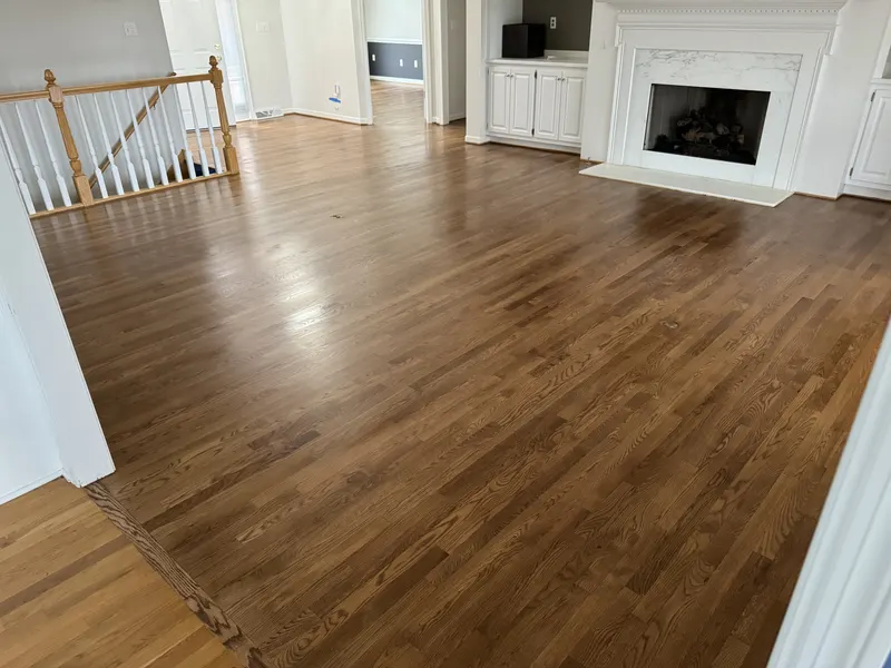 Refinished hardwood floor in a living room with a fireplace, Franklin, WI