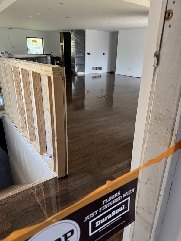 Newly finished dark-stained hardwood floor in a new-construction home, Glendale, WI