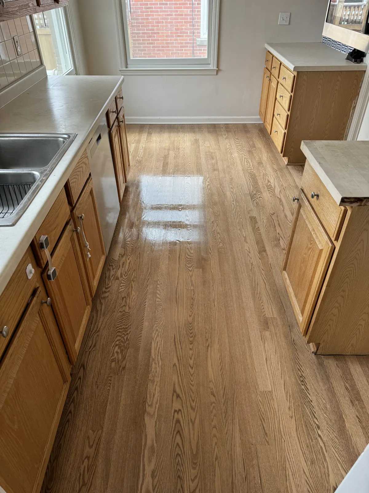 Refinished hardwood floor in a galley kitchen, Whitefish Bay, WI