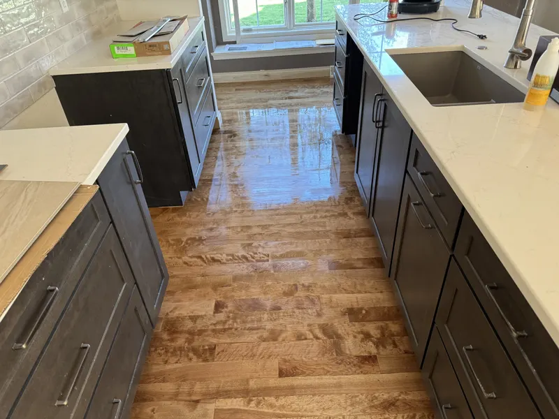 Dark-stained maple floor with a glossy finish in a kitchen, Pewaukee, WI