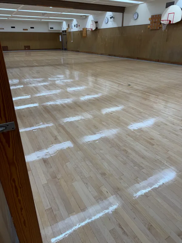 Refinished gymnasium floor with a glossy new finish, Milwaukee, WI