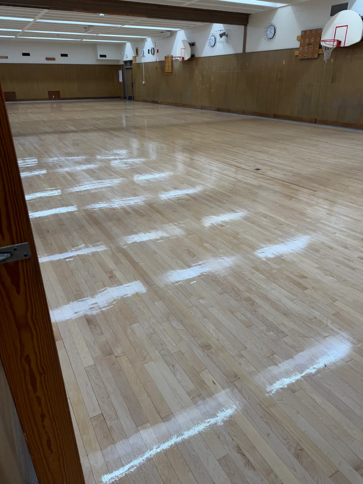 Refinished gymnasium floor with a glossy new finish, Milwaukee, WI