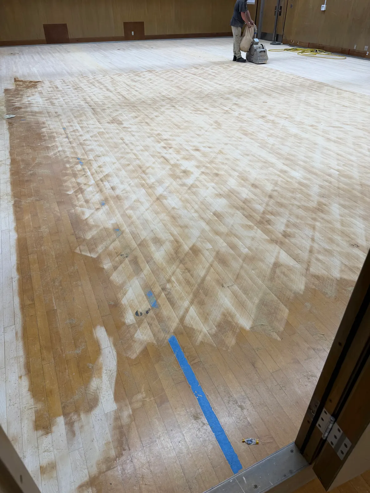Old finish being sanded off a gymnasium floor in Milwaukee