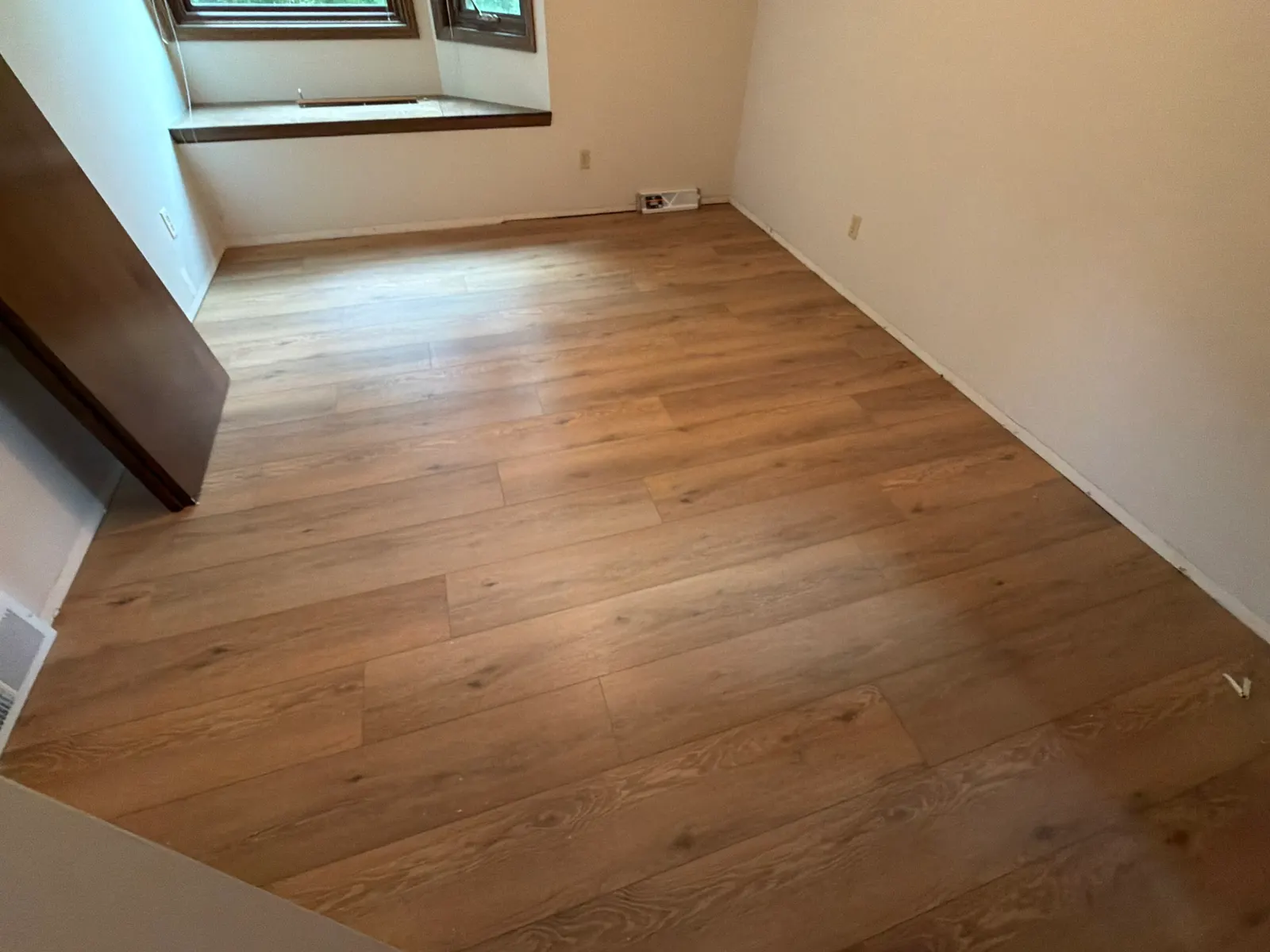 New luxury vinyl plank floor in a room with a bay window, New Berlin, WI
