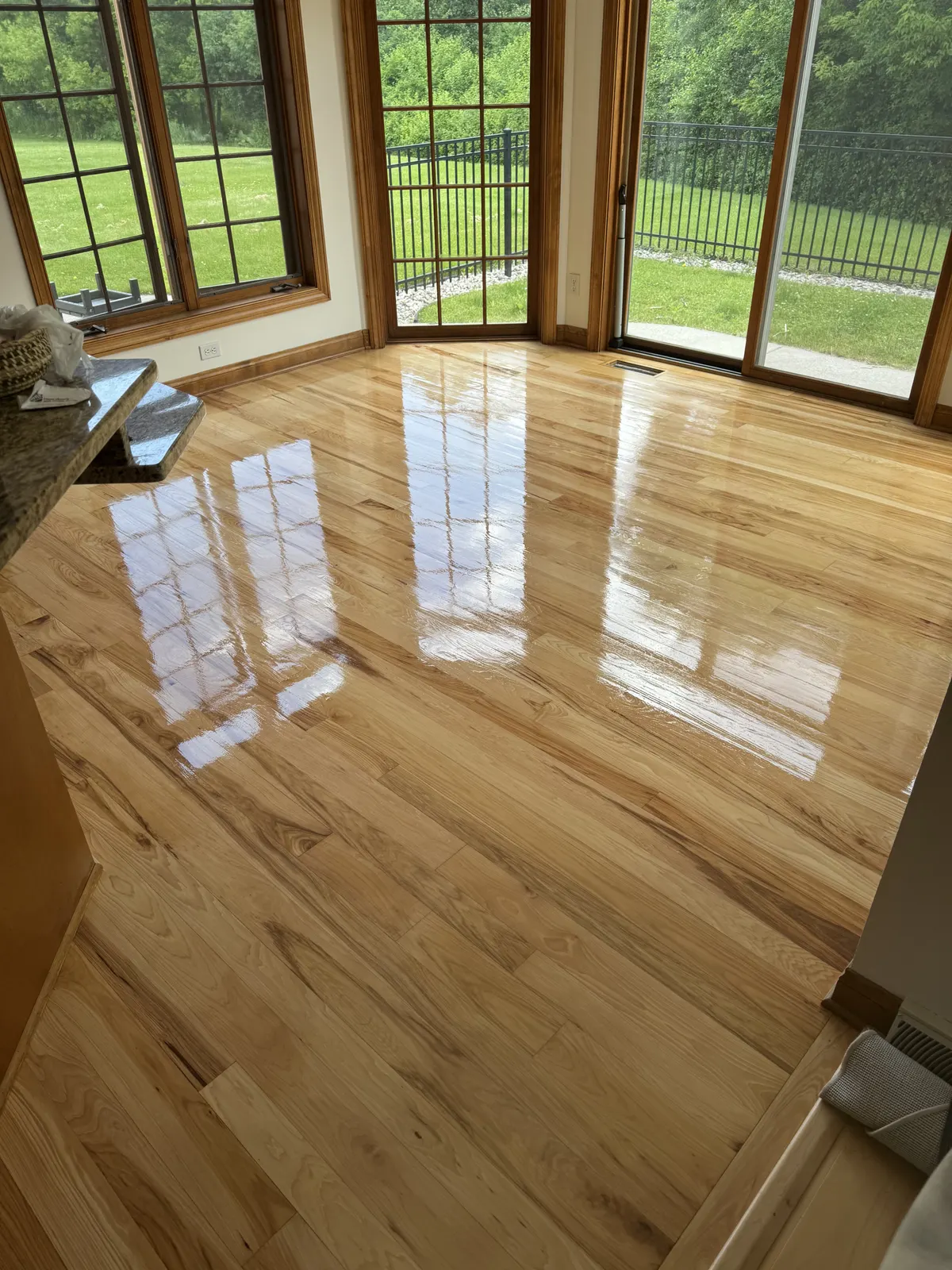 Refinished hardwood floor in a dining area with patio doors, Oconomowoc, WI