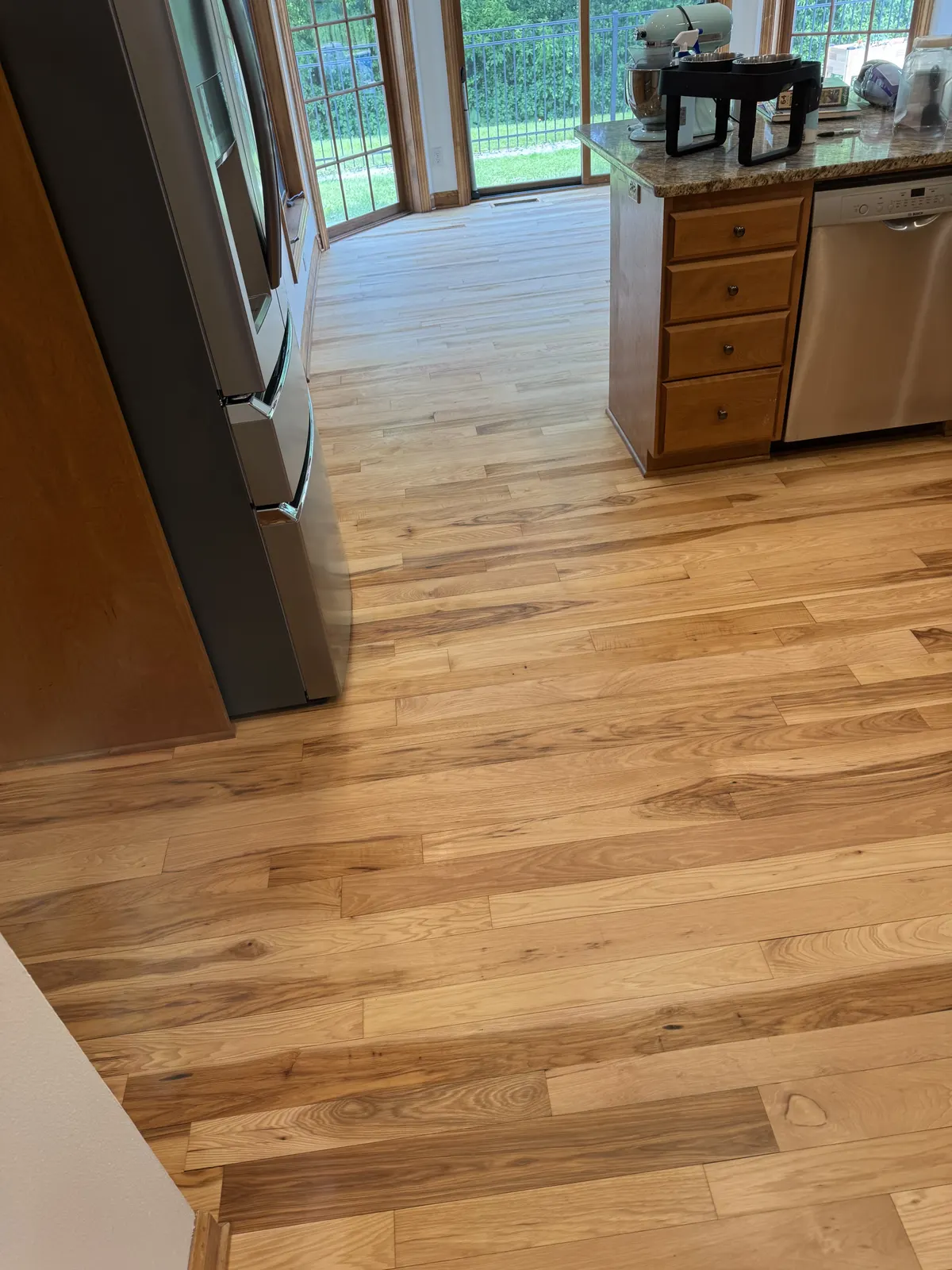 Kitchen hardwood floor sanded after water damage repairs in Oconomowoc