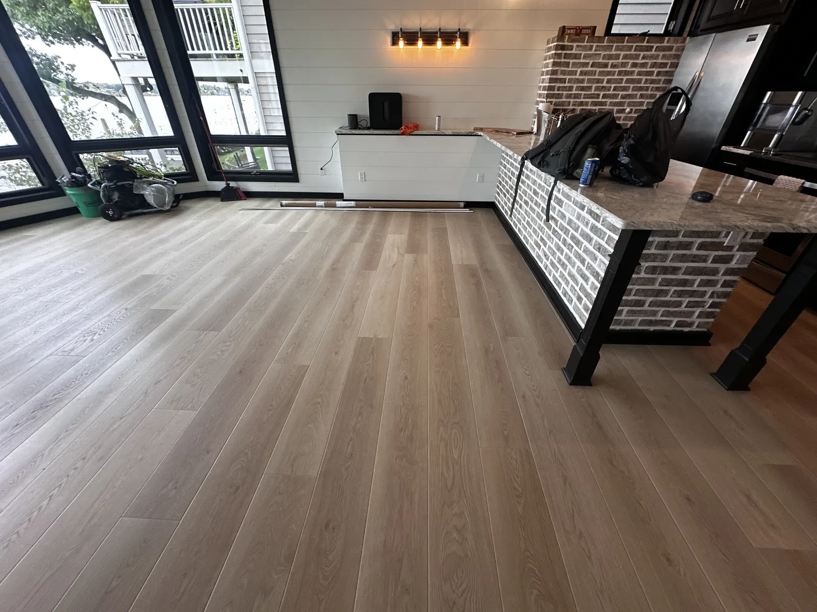 Finished luxury vinyl plank floor in a lower level with lake-facing windows, Pewaukee, WI