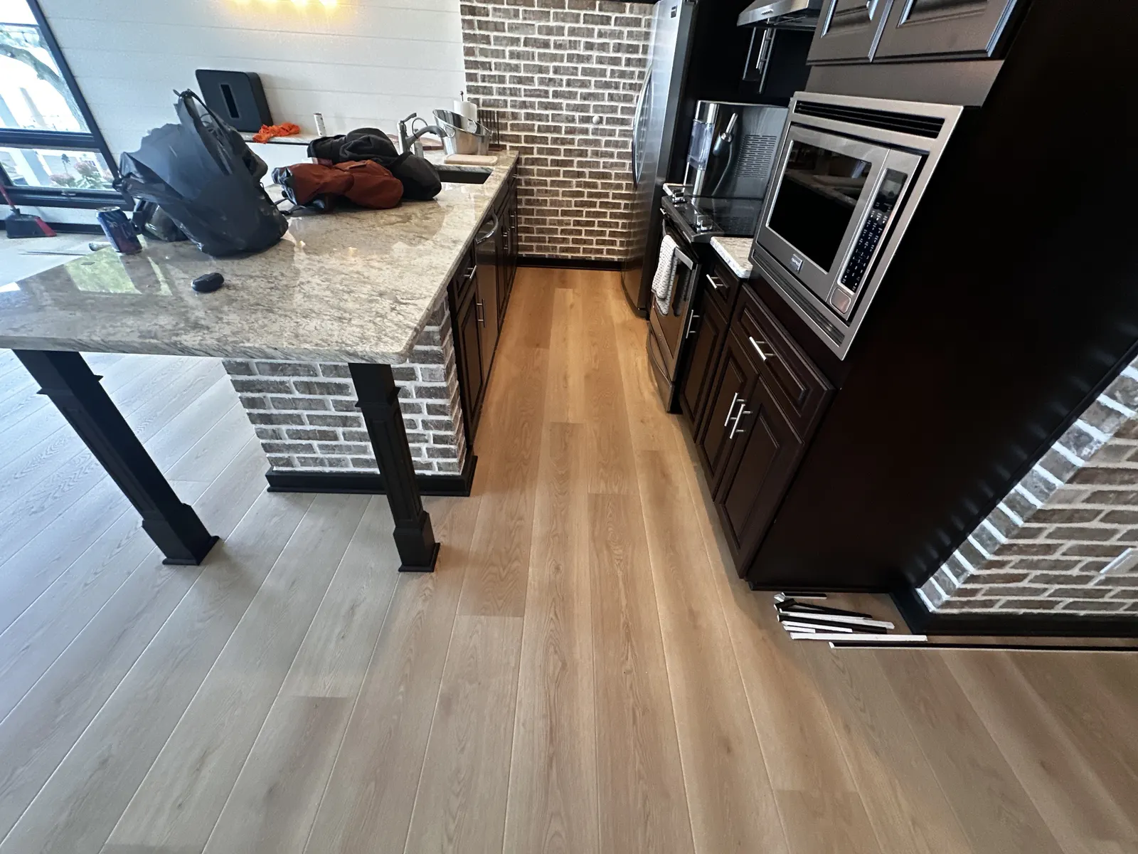 Luxury vinyl plank floor through a lower-level kitchenette in Pewaukee