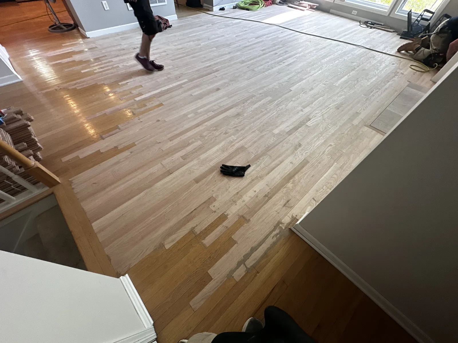 New boards weaved into an existing hardwood floor during installation