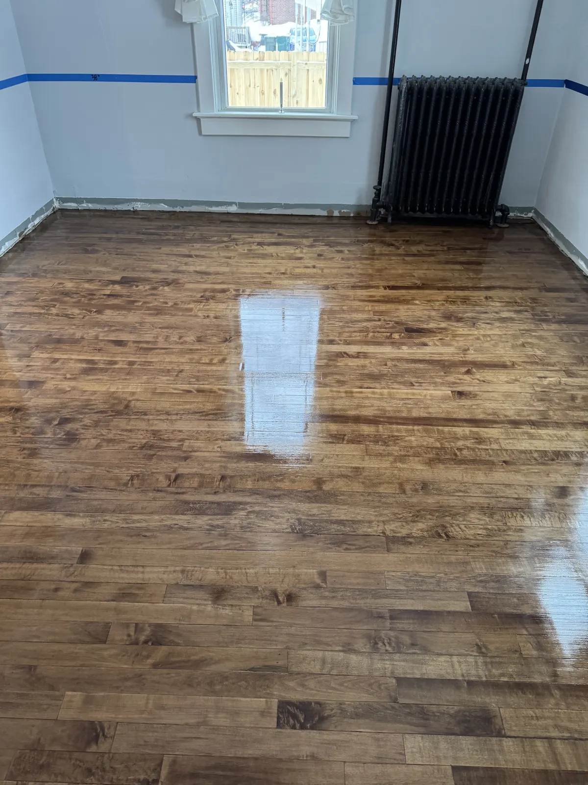 Refinished original maple floor in an old home with a radiator, Richfield, WI