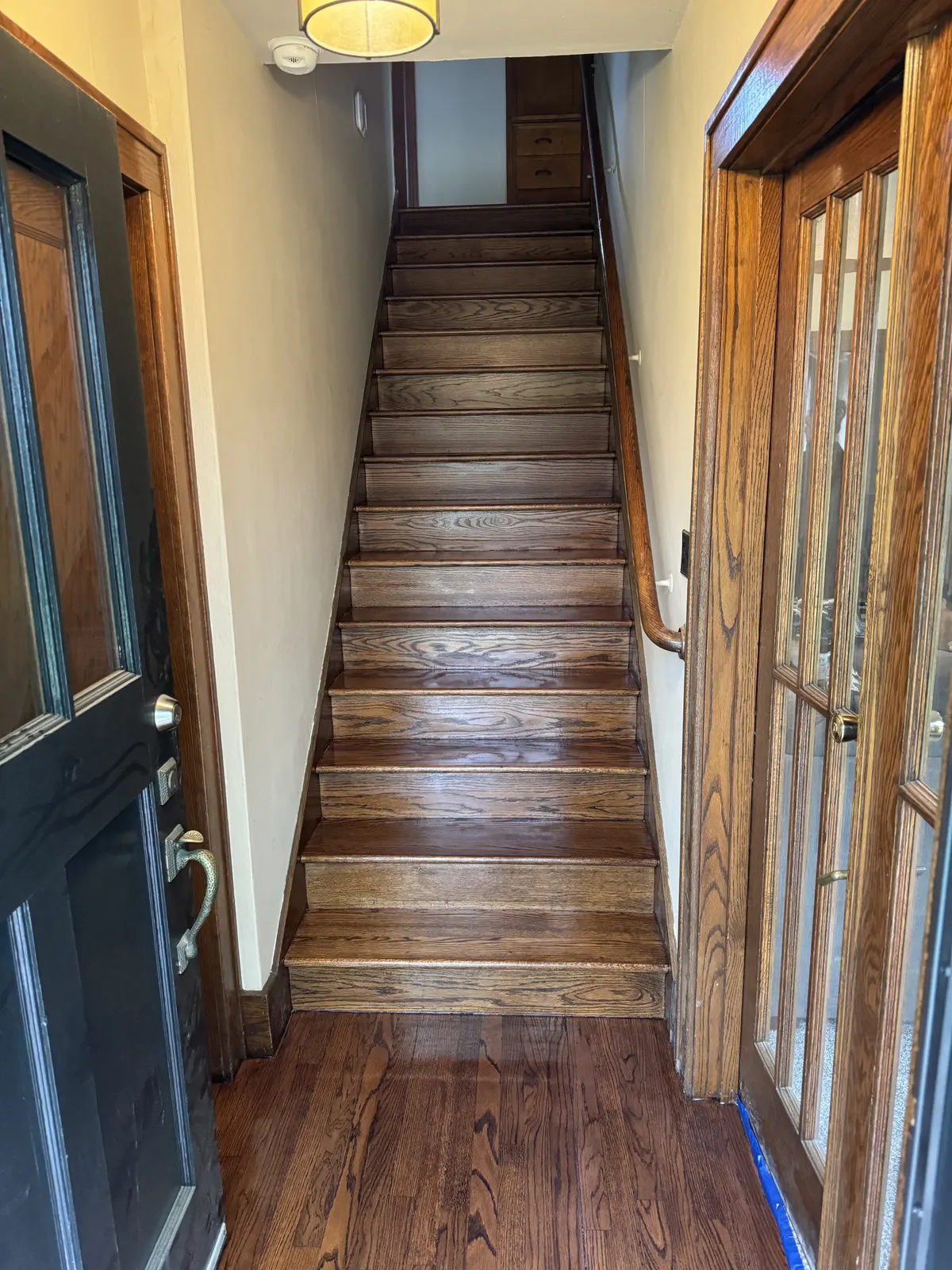 Refinished staircase treads and risers seen from the entry, Wauwatosa, WI