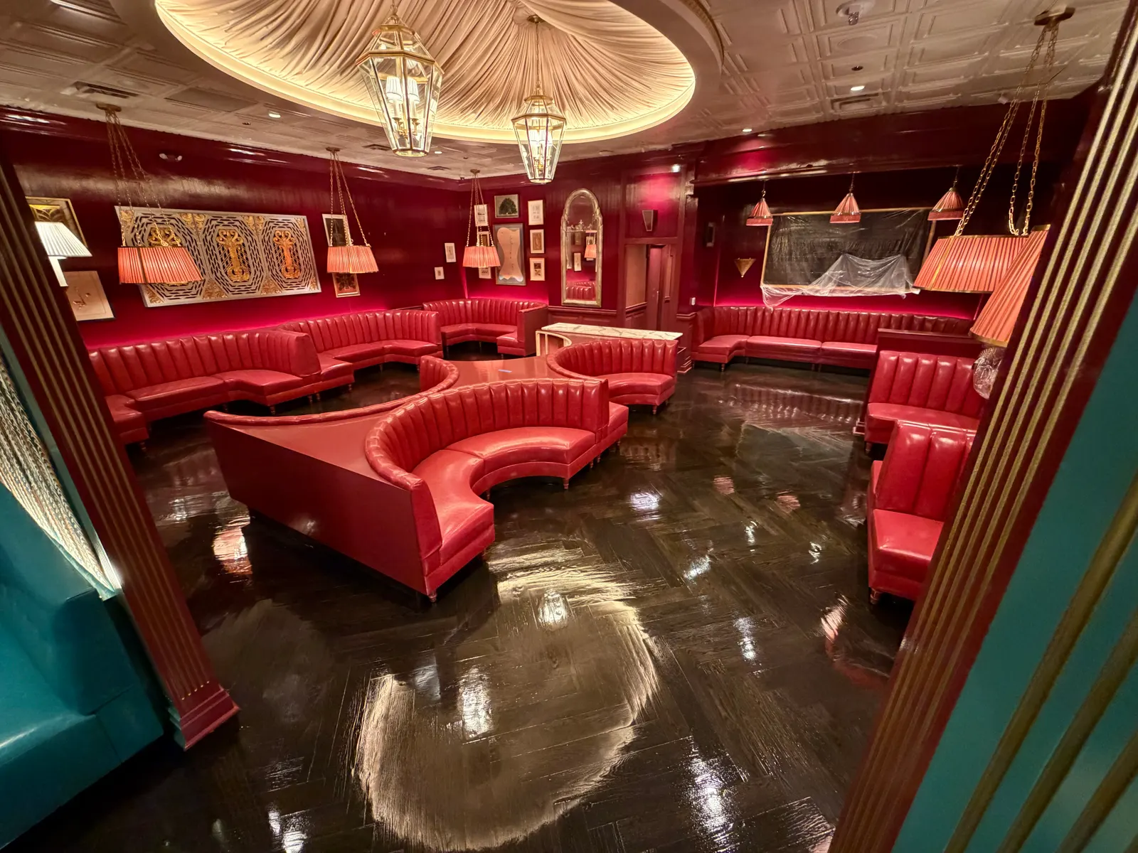 Finished dark herringbone floor in a steakhouse dining room with red banquettes, Milwaukee, WI
