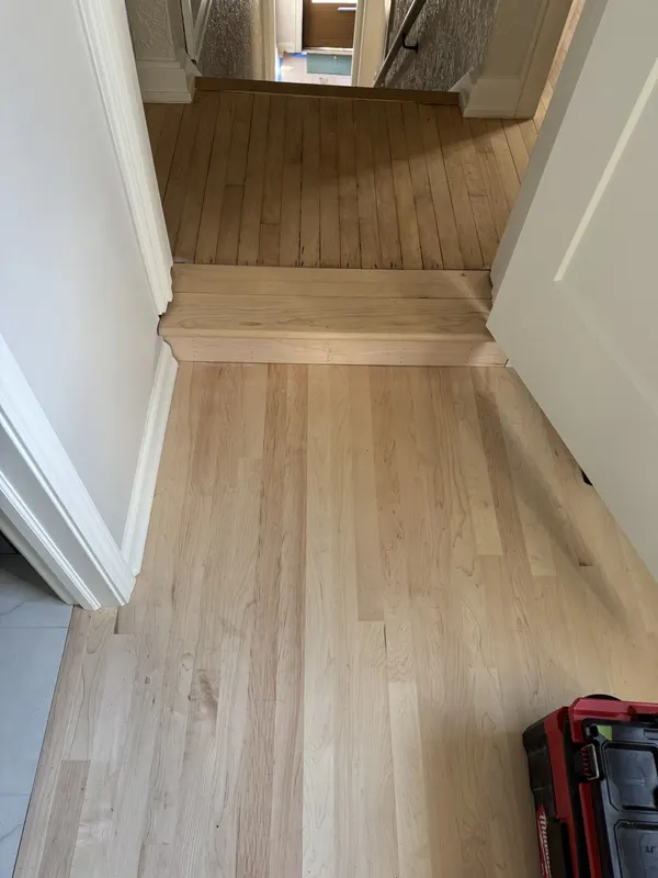 New maple flooring stepping down into a sunken bedroom addition, Whitefish Bay, WI